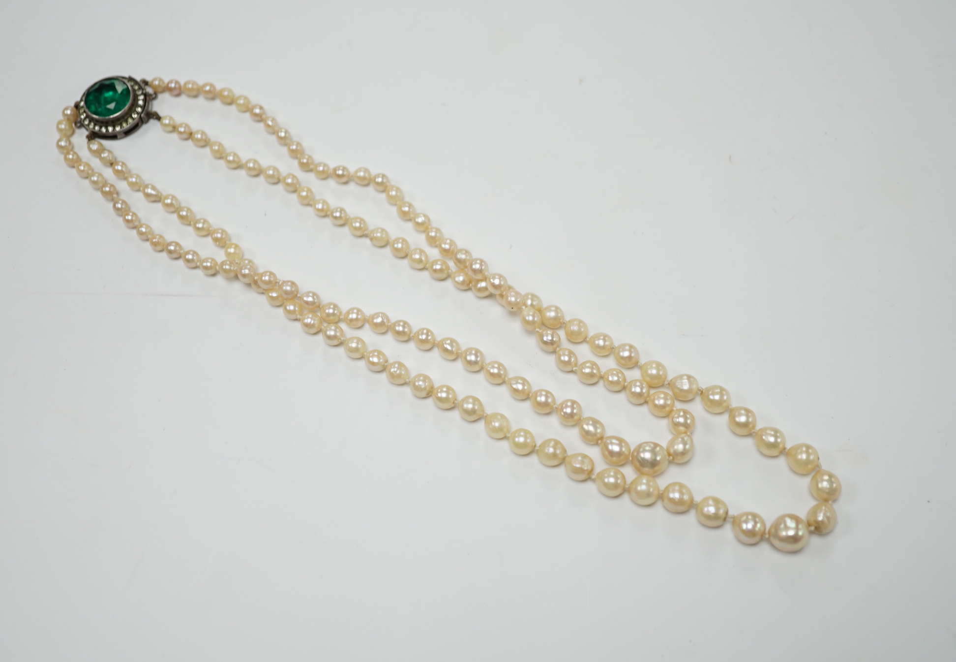 A double strand graduated cultured pearl necklace, with two colour paste set white metal clasp, 39cm.